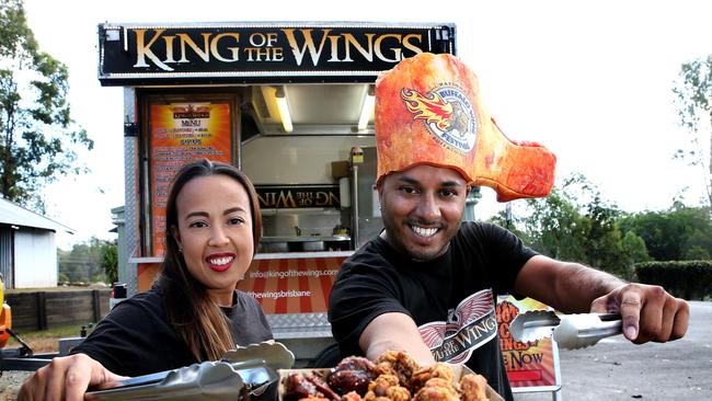 Dylan and Katrina Pires at the King Of The Wings serving window — Dylan wearing a wing-shaped foam hat
