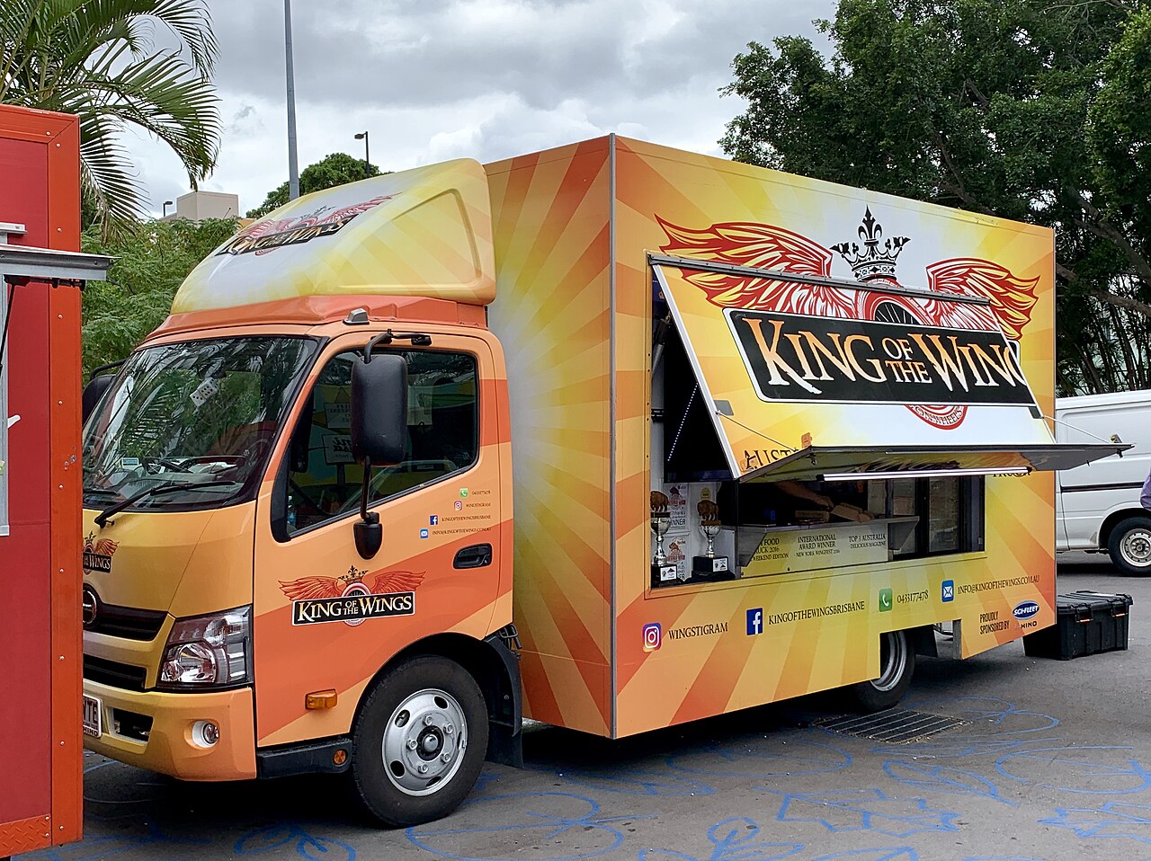 The King Of The Wings food truck — sunburst orange with winged crown logo