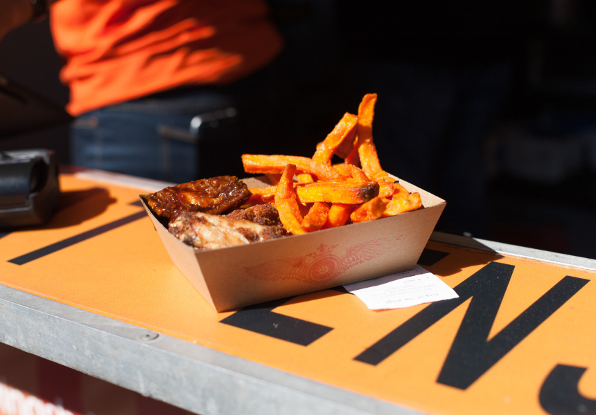 Sweet potato fries being seasoned in the King Of The Wings fryer — kitchen action